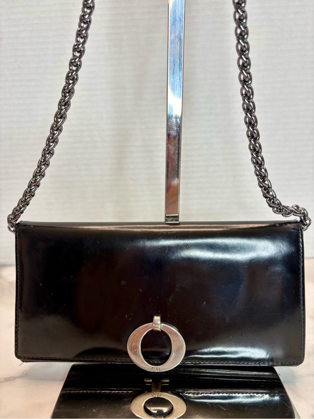 Christian Dior black leather wallet W/silver "CD" logo ring closure.